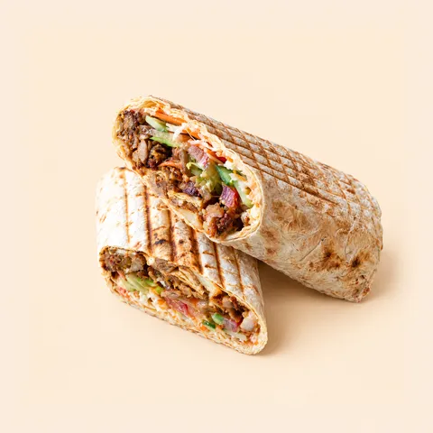 Chicken shawarma rolled in thin lavash, cut in half