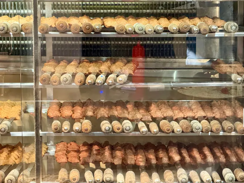 Fridge with rows of raw kebab skewers