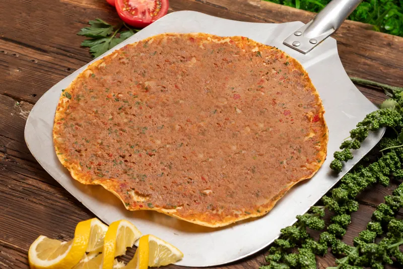 Lahmajo on a peel with lemon
